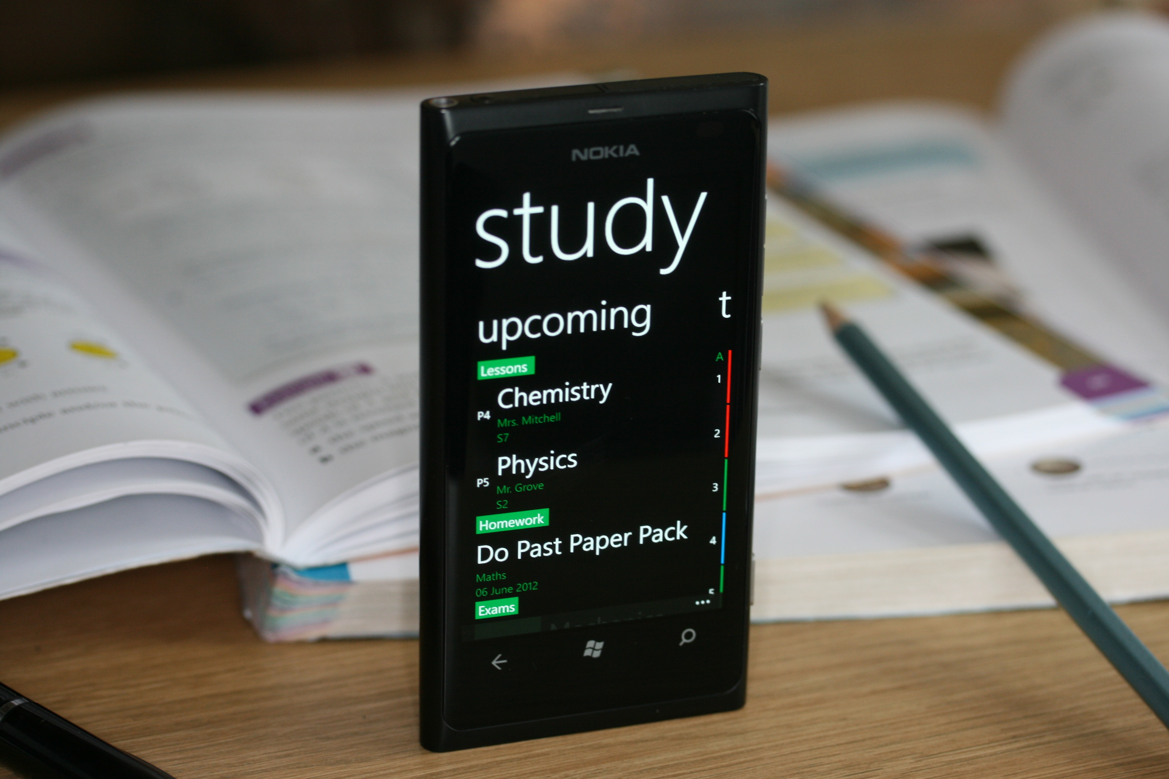 Upcoming lessons and homework on a Nokia phone beside textbooks.